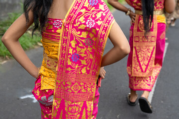 Balinese traditional wear while attending ceremonial event