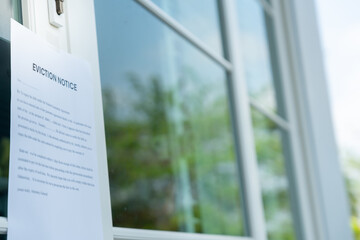 document with the text eviction notice, Civil servant sticks a notice of eviction of the tenants hangs on the door of the house, debt, property, loan, agent, bankruptcy, dispossess, problem