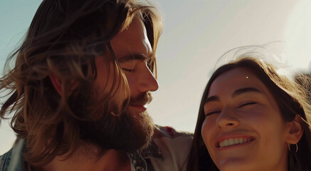 A cute woman with brown hair and a man with a long dark beard engage in conversation on the beach, conveying connection and communication in a serene seaside setting