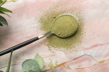 Green powder moringa in the spoon. Concept of nutritional supplement, dieting, detox, preventive...