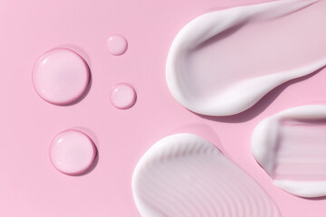 composition of smears of cream texture on a pink background