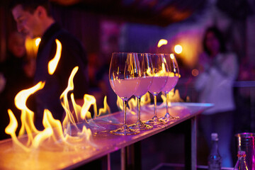 Glasses stand on the bar counter on fire