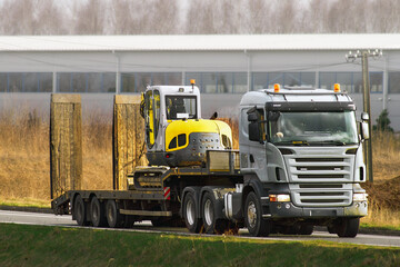 Industrial Excavator and Flatbed Truck Ready for Earthworks