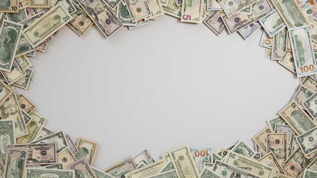 Mixed Denomination Bills Border on White Surface. Finance Background with copy-space.