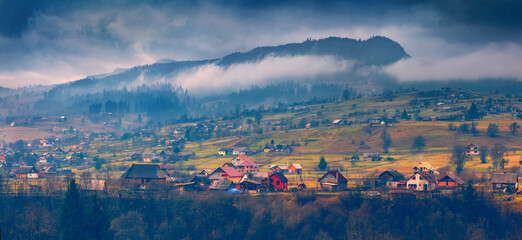 Dramatic autumn scenery. Panoramic morning view of Carpathian village. Majestic outdoor scene of...