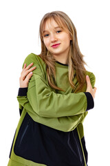 Embrace equity concept in a portrait of fourteen year old girl, looks with happy expression, isolated on white background. Pretty caucasian girl hugging herself, smiling and posing in studio.