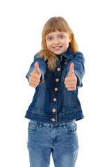 Portrait of ten year old kid doing thumbs up gesture, isolated on white background. Blondy caucasian girl in jeans clothes smiling happy at camera and posing in studio. - obrazy, fototapety, plakaty