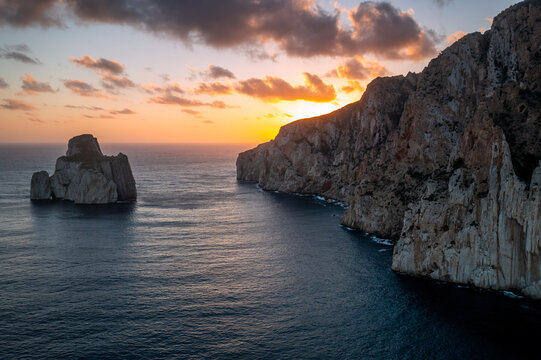 Aerial drone view of Pan di Zucchero island and Porto Flavia at sunset