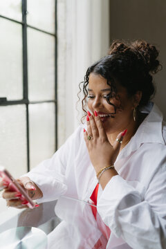 Woman taking on phone reacting to message