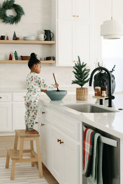 Toddler Baking Cookies in Christmas Pajamas
