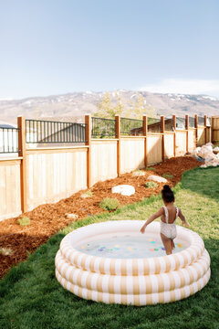 Toddler Girl in Backyard Pool