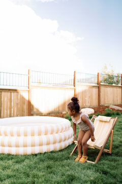 Toddler Girl Swimming in Inflatable Pool Backyard