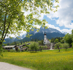 spring landscape village church Obergrainau and cemetary, Wetterstein alps - 793669261