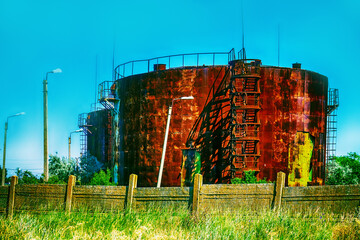 Old rusty oil tanks (fuel reservoir, oil barrel). Evidence of economic stagnation and environmental...