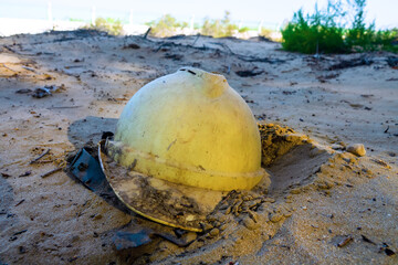 Hastily abandoned construction helmet in the sand