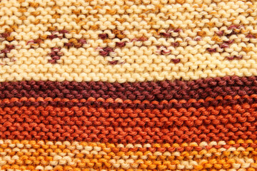 background of beige and brown knitting texture made of wool