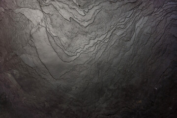 Black stone wall texture for background.