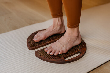 Acupressure in action with feet firmly placed on wooden sadhu boards