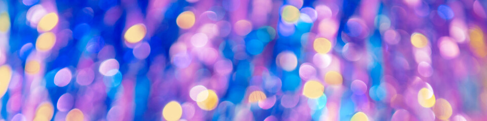 Blue-pink abstract background of blurred shiny lights. Horizontal banner