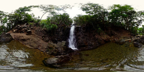 Diquisit Falls in green forest. Waterfall in the tropical mountain jungle. VR 360. Philippines.