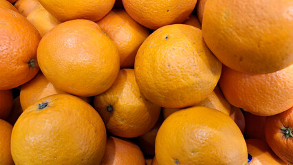 Pile of fresh oranges in supermarket.