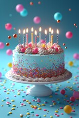A beautiful blue birthday cake with lit candles and colorful sprinkles on a blue background.