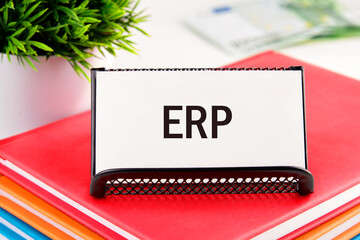 Abbreviation ERP - Enterprise Resource Planning on white business cards in delivery on a light background - obrazy, fototapety, plakaty