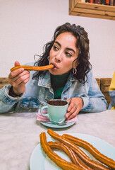 Oriental woman enjoying a chocolate with churros for a snack. Lifestyles concept. - obrazy, fototapety, plakaty