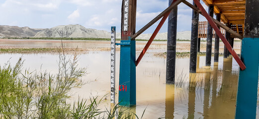 The water level meter of a wetland demonstrates the scarcity of water that exists due to the lack...