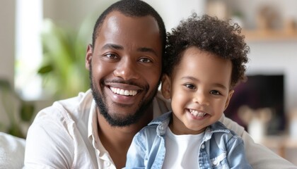 A man and child sharing a happy moment, smiling on a couch