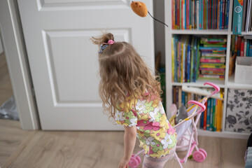 little girl having fun at home, movement and hair - obrazy, fototapety, plakaty
