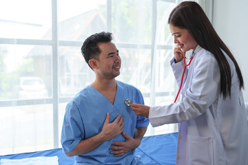 A female doctor uses a cardiac stethoscope to treat patients to analyze and listen to whether their...