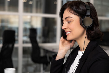 Young friendly operator woman agent with headsets working in call center