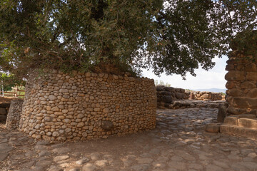 Old stone wall in the garden. Ancient historical city in Israel. Natural stone wall.