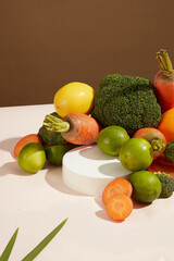 A group of vegetables neatly arranged on table against on brown background with empty podium for displaying product of vegetarian. Agriculture ingredients template with blank space, top view