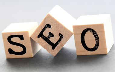 SEO words on wooden blocks and gray background.