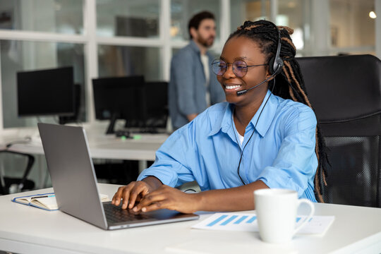African American woman call center operator agent consulting customer wearing headset