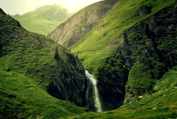 Waterfalls, majestic and serene, flow gracefully over rugged terrain, captivating with their beauty...