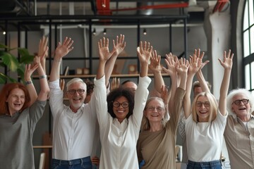 Group of senior people raising their hands in a high five in the office