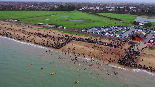 Aerial panning across Gosport New Years Day Swim UK 4K