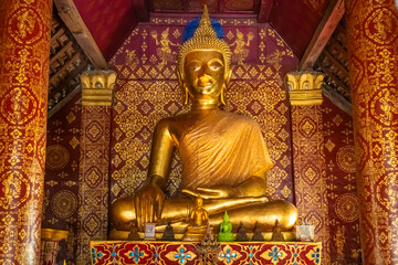 The gold Buddha statue at Wat Sibounheuang in Luang Prabang, Laos
