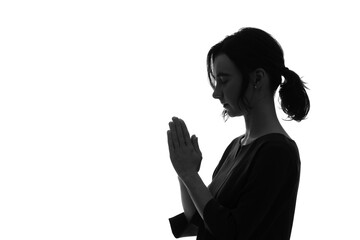 Profile silhouette of a white woman praying.