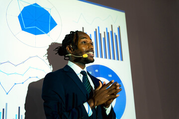 Black man giving a presentation using a projector