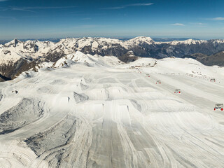 Aerial drone view of  French Alps Mountains glacier near Grenoble. Europe alps in winter. Les deux alpes resort. Winter mountains beautiful alpine panoramic. Mountains aerial snow winter view.