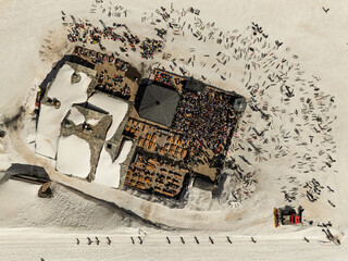 People dancing in a mountain bar in the ski resort of Les 2 Alpes, France. Aerial drone view of...