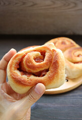 Closeup of Mouthwatering Low Sugar Healthy Apple Cinnamon Roll in Hand