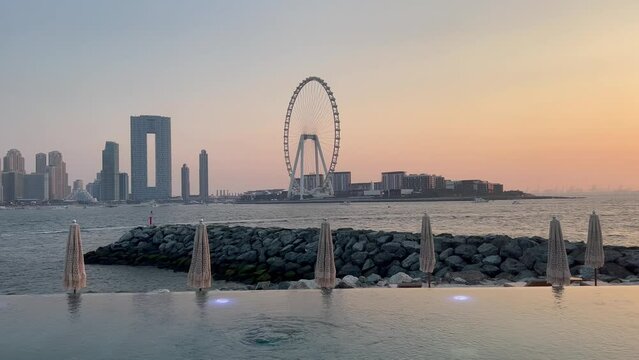 Dubai Jumeirah beach with marina skyscrapers in UAE. Luxurious sandy beach. Boat