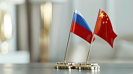 Two flags of Russia and China were placed on the table in front of a white background. A gold stand holds both flags, creating an elegant display