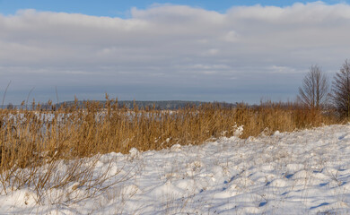 the lake is covered with ice in winter and sunny weather