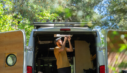 Caucasian man fixing his camper van